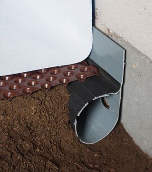Closeup of a crawl space drainage system installed in Whitehall