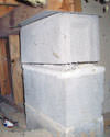 Concrete crawl space support posts in Hanover that are showing signs of failure as they sink into the earth.