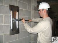 Attempting to straighten a bowed foundation wall by straightening a wall anchor system in a Easton  home.