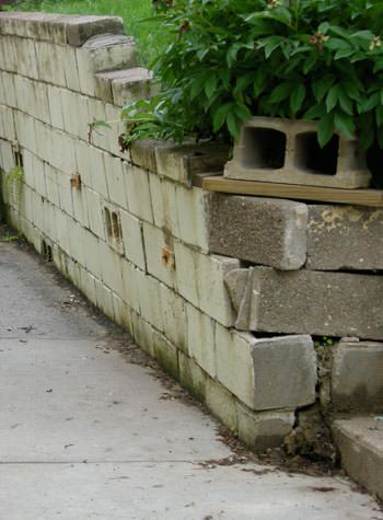collapsing retaining wall with severe damage in Kingston