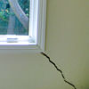A long, diagonal crack that begins at a window corner of a Pittston home