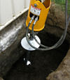 Installing a helical pier during a foundation repair in Allentown