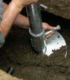 Allentown helical pier installation nearing completion, with the blade being advanced into the foundation soils.