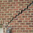 stair step cracking reaching from a window along the foundation wall in York