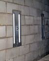 an inside view of foundation wall anchors installed along a basement wall to brace and repair the structure in Williamsport