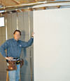 Installing wall panels on top of our basement wall insulation in Wilkes Barre
